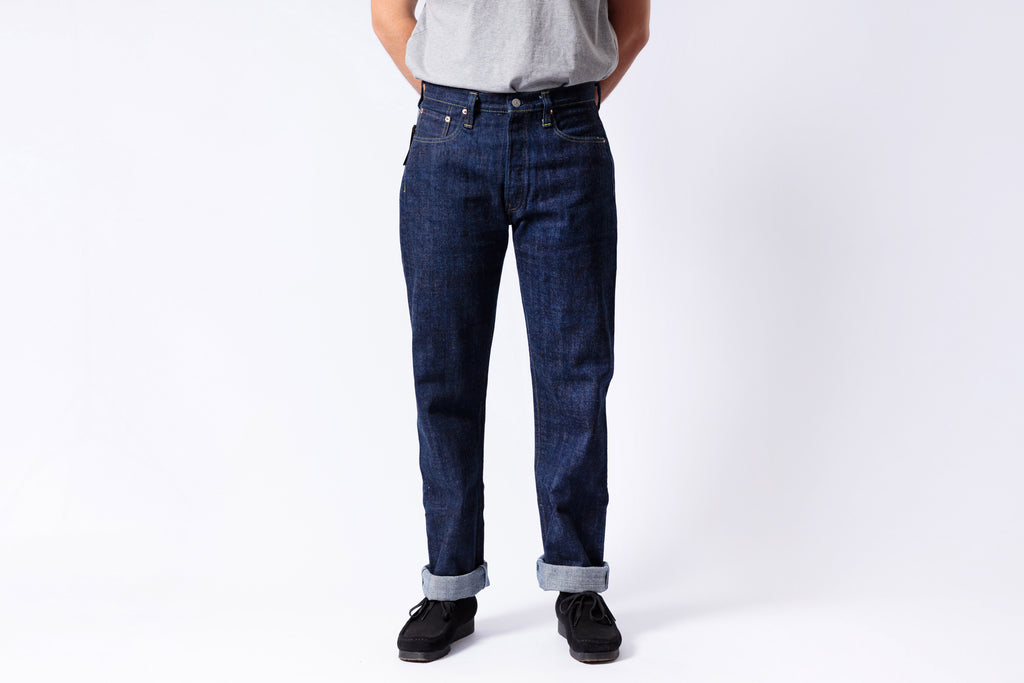 Person wearing blue jeans on a white background