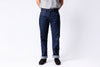 Person wearing blue jeans on a white background