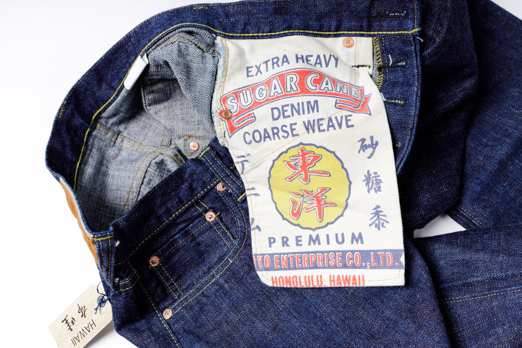 Blue denim jacket with a visible brand label on a white background