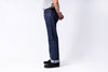 Person wearing dark blue jeans on a white background