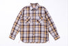 Plaid shirt with a pattern of brown, yellow, and gray on a white background