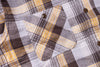 Close-up of a plaid shirt with yellow, black, and white pattern
