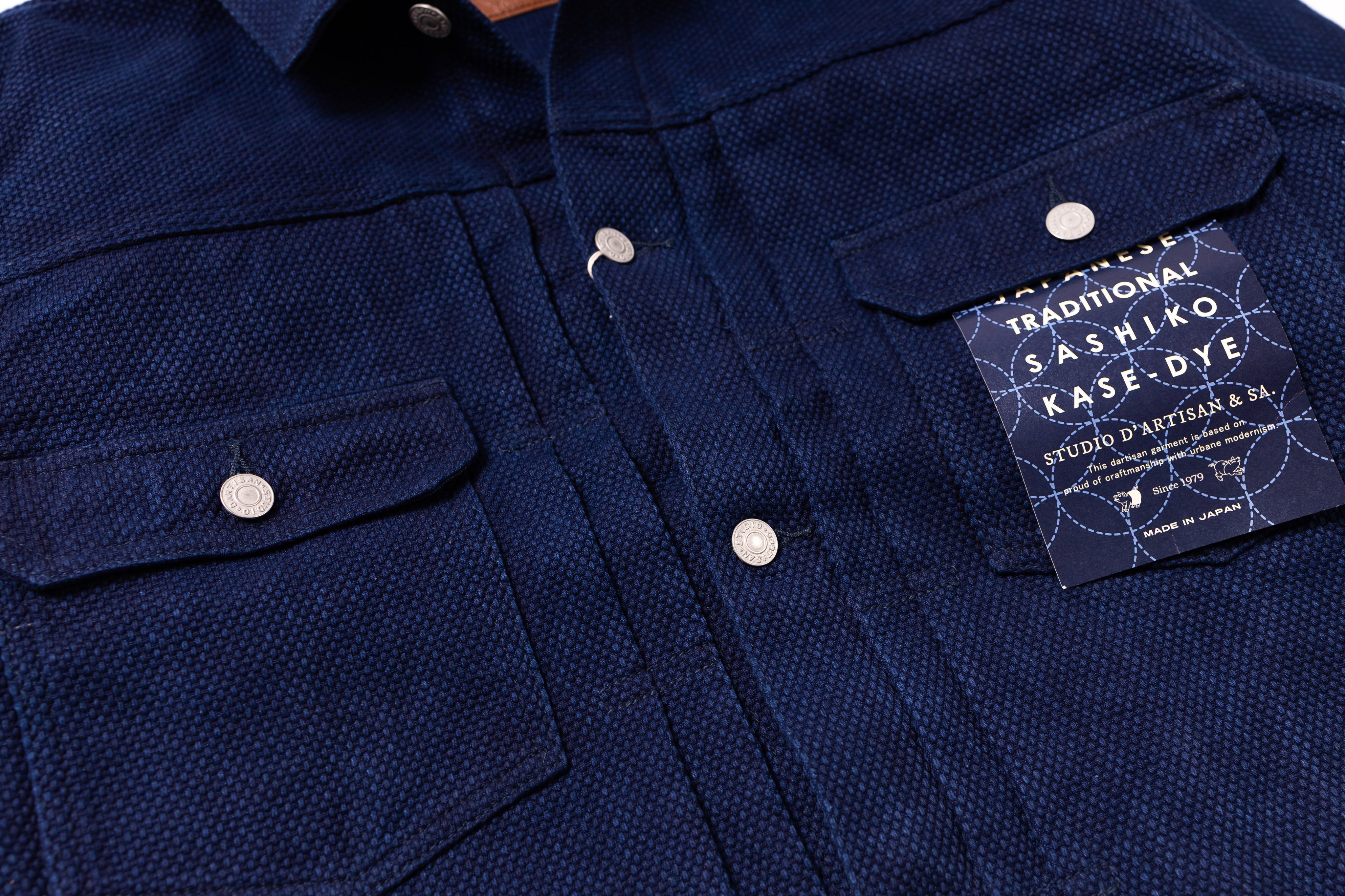 Navy blue shirt with a label on a white background