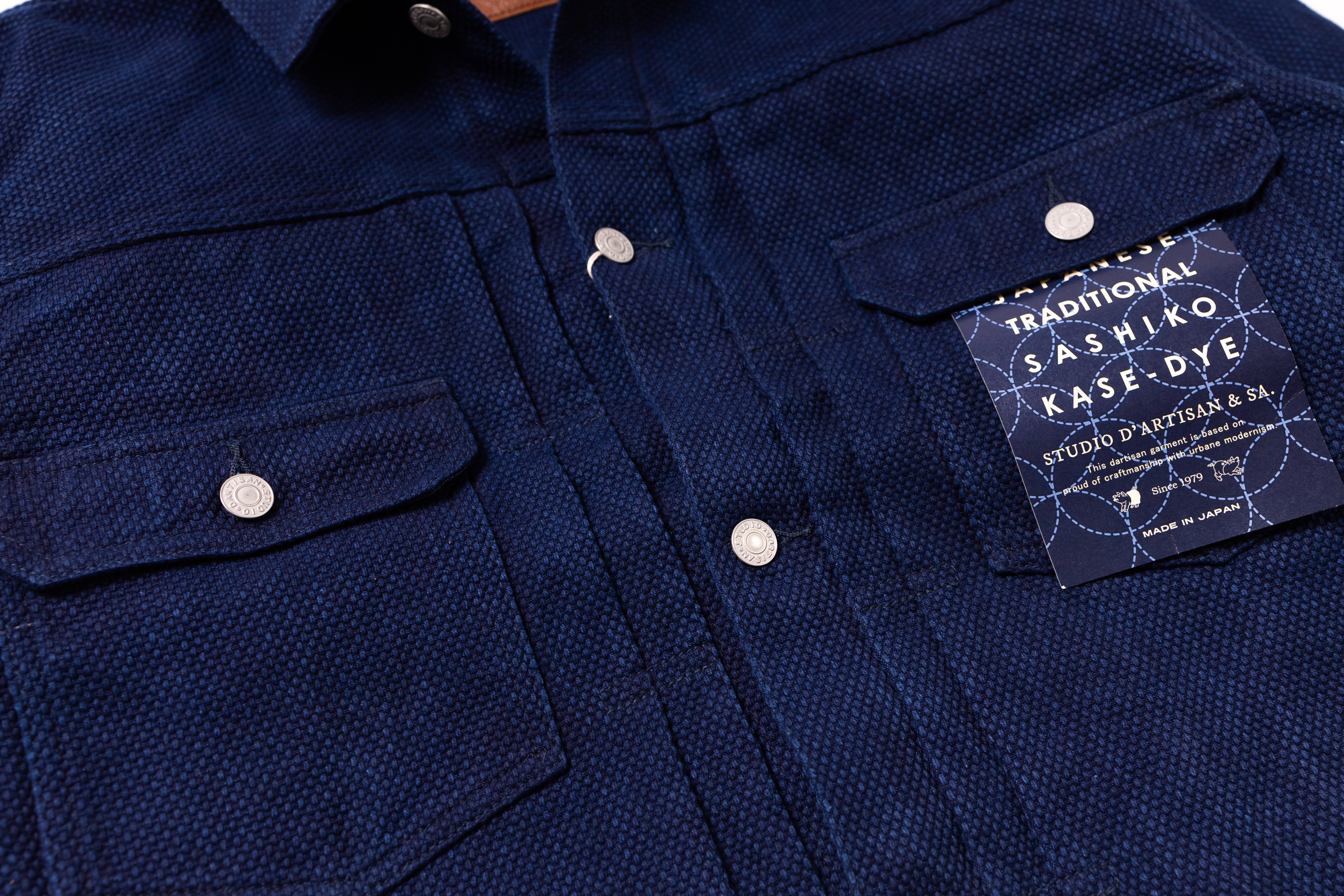 Navy blue shirt with a label on a white background