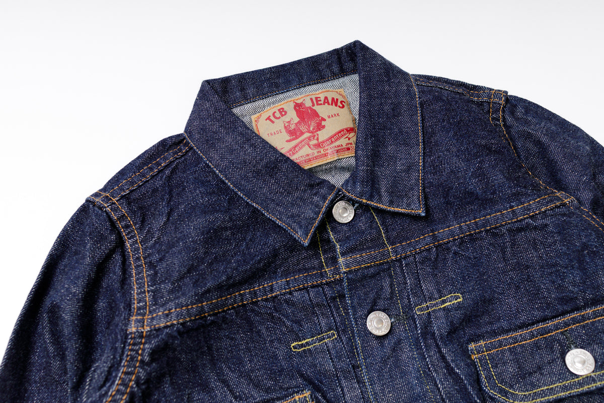 Denim jacket with a brand label on a white background