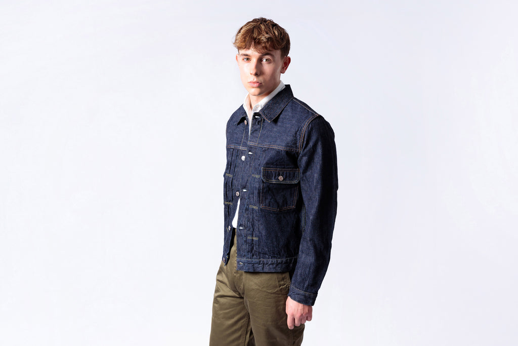 Man wearing a blue denim jacket on a white background