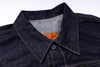Close-up of a denim shirt collar with a brand label on a white background