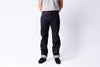 Person wearing dark jeans and a gray shirt on a white background
