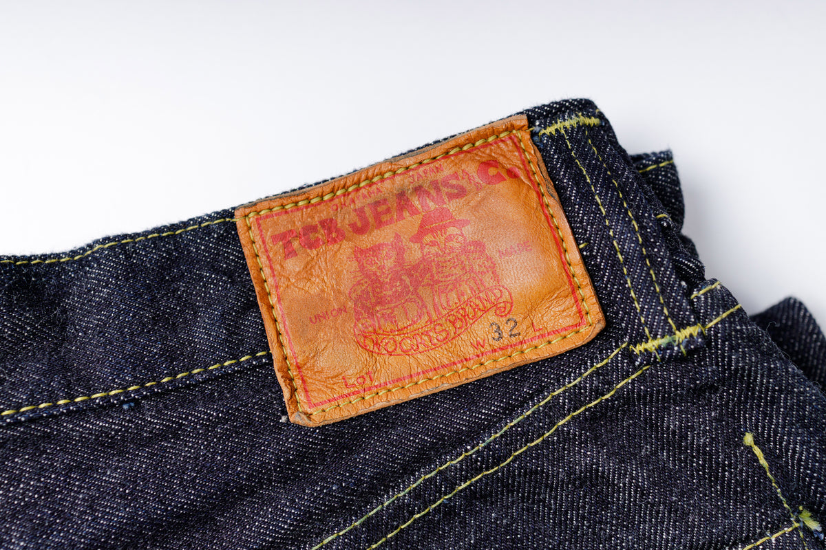 Close-up of a label on a pair of jeans with a white background