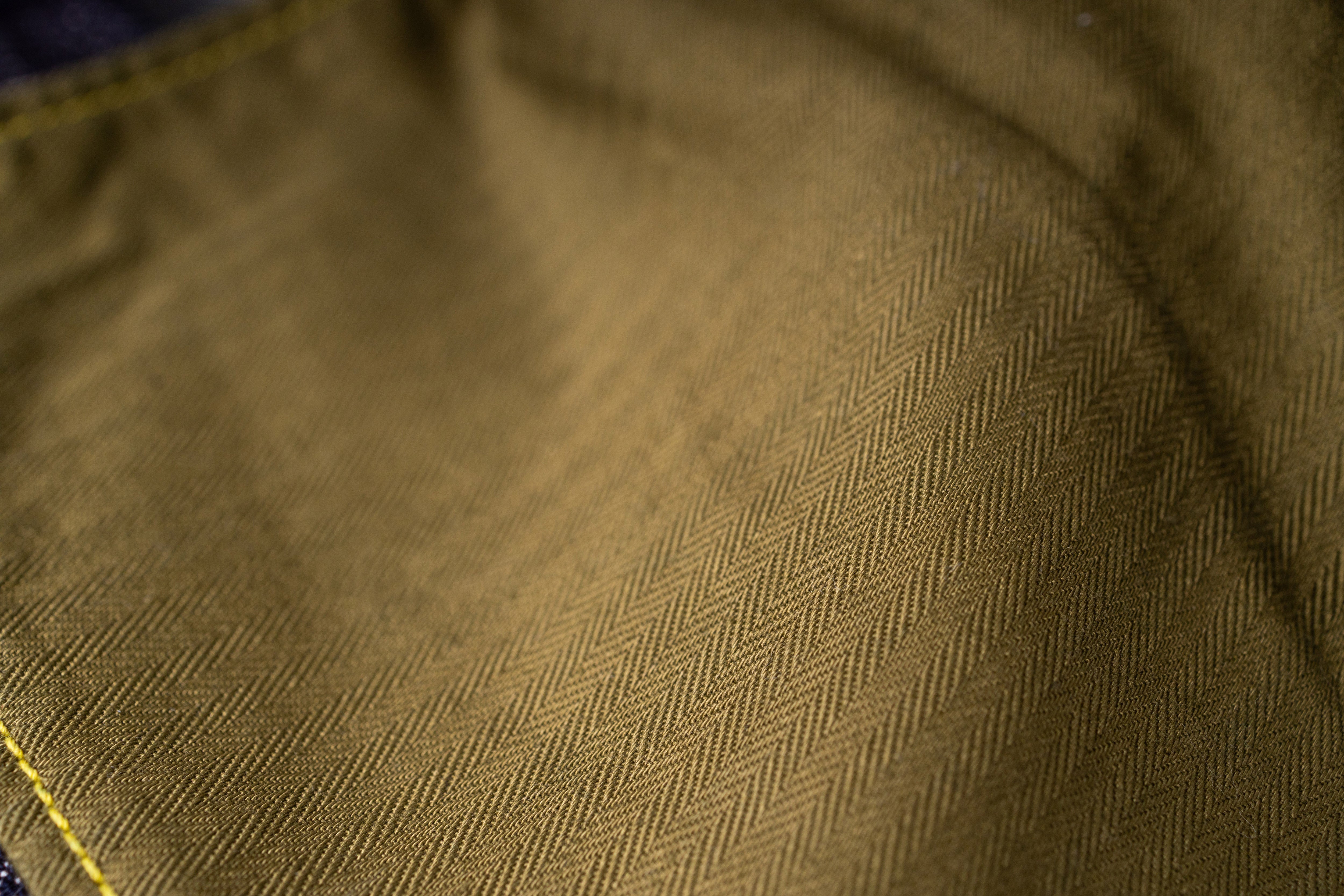 Close-up of brown fabric texture with a subtle pattern