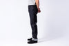 Person wearing dark jeans on a white background