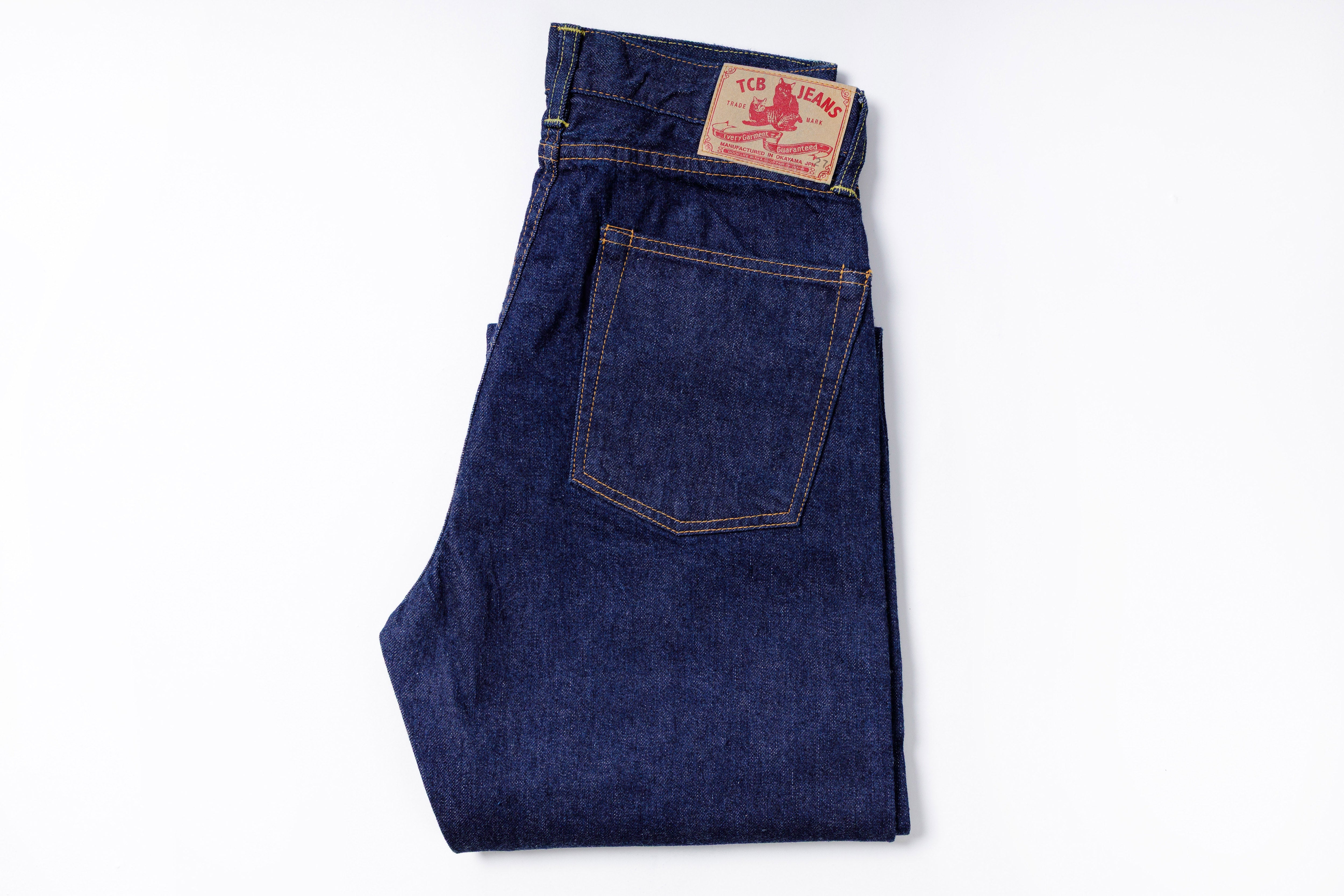 Folded pair of blue jeans on a white background