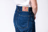 Person wearing blue jeans with on a white background