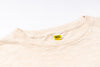 Beige t-shirt with a label on a white background