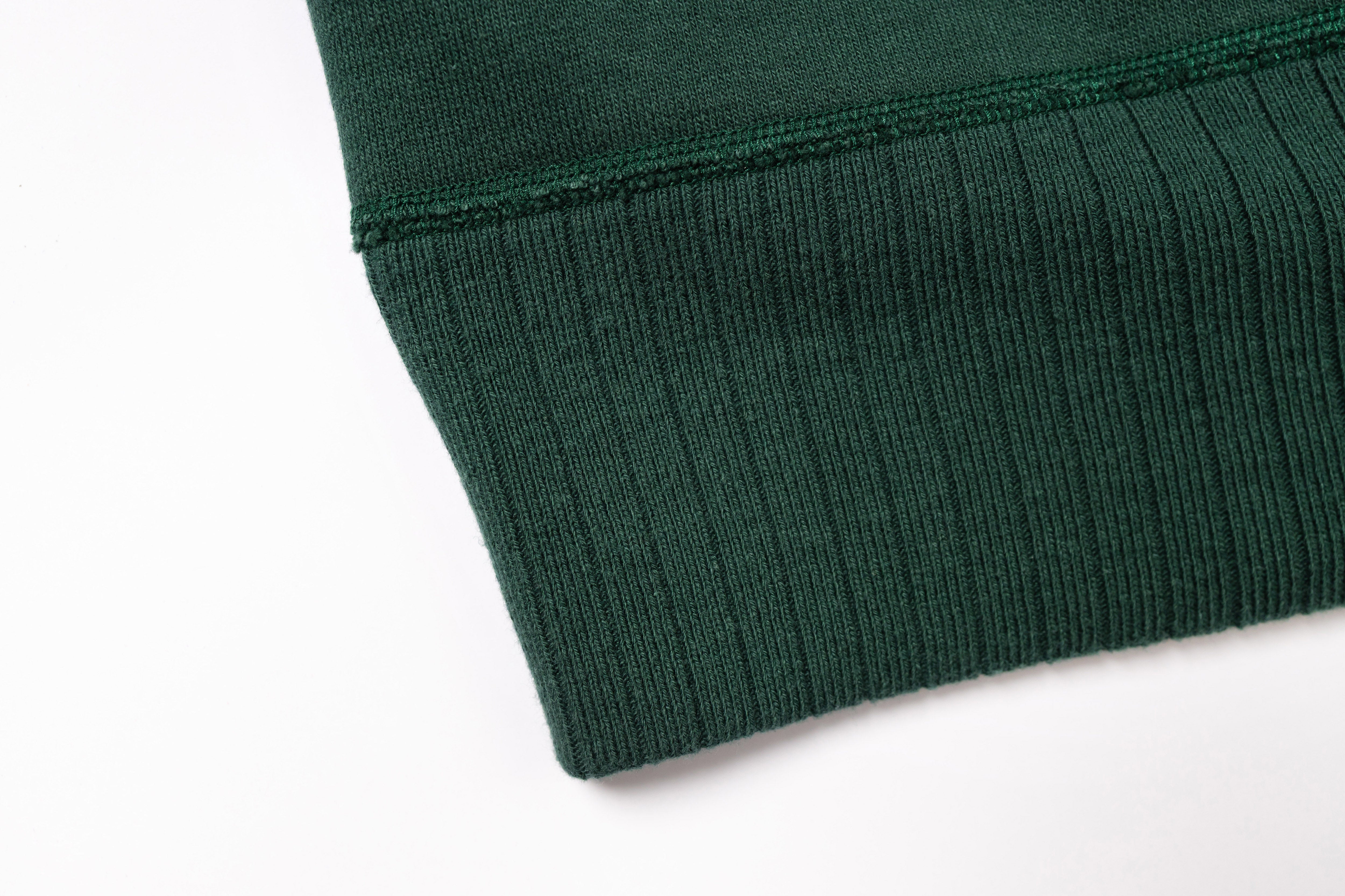 Close-up of a green fabric edge on a white background
