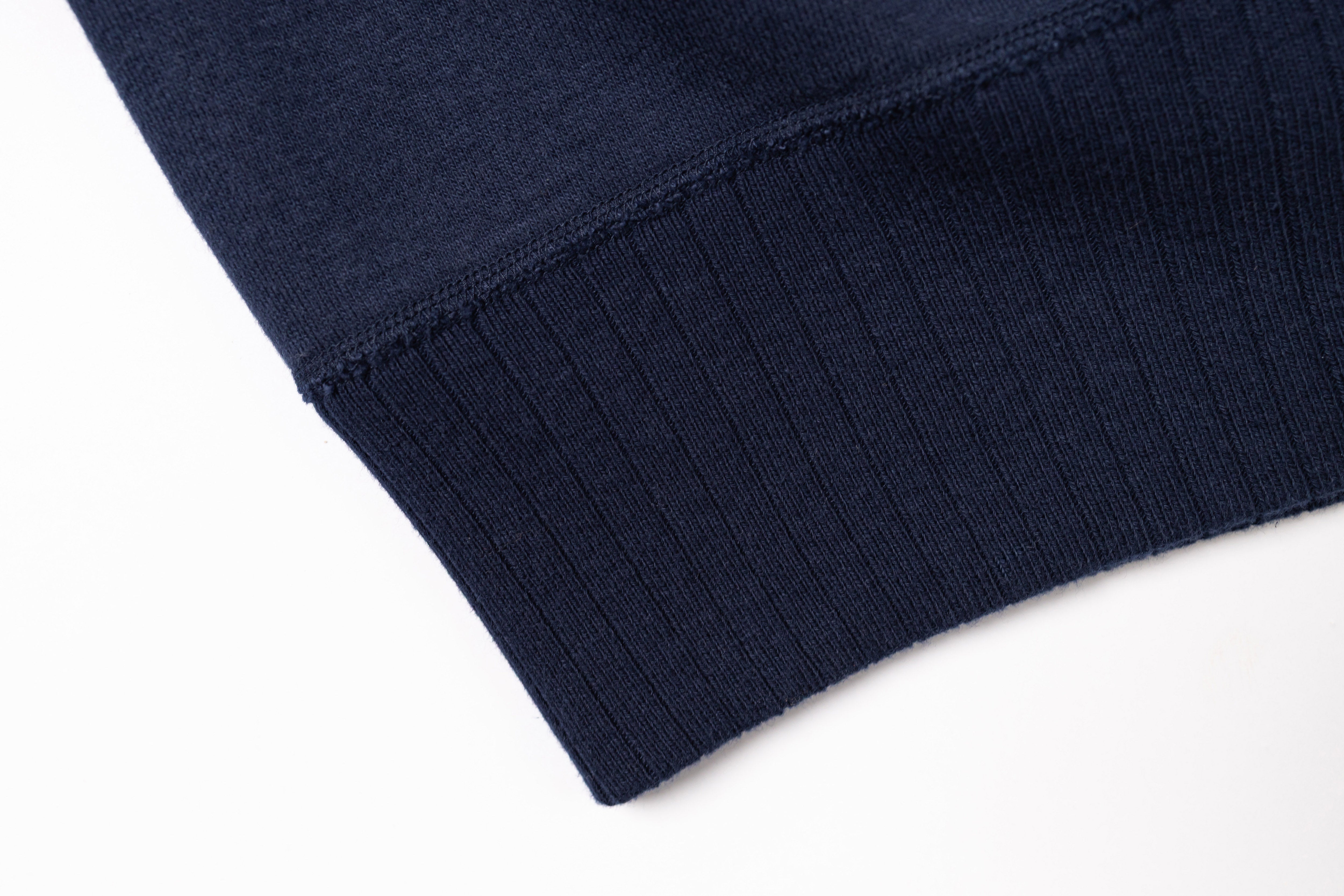 Close-up of a navy blue fabric edge on a white background