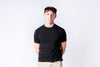 Person wearing a black t-shirt and cap on a white background